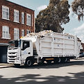 white truck used to transport skip bins, with a white skip bin on it_edited.jpg
